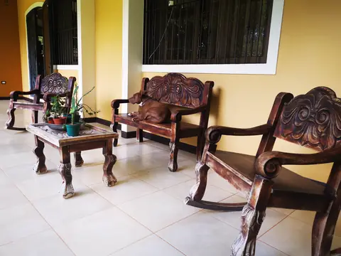 The veranda with wooden furniture — Main house, Rio Ángel Bio-reserve