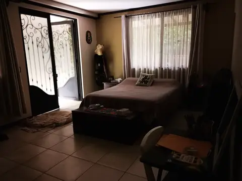 A bedroom looking onto the garden — Main house, Rio Ángel Bio-reserve