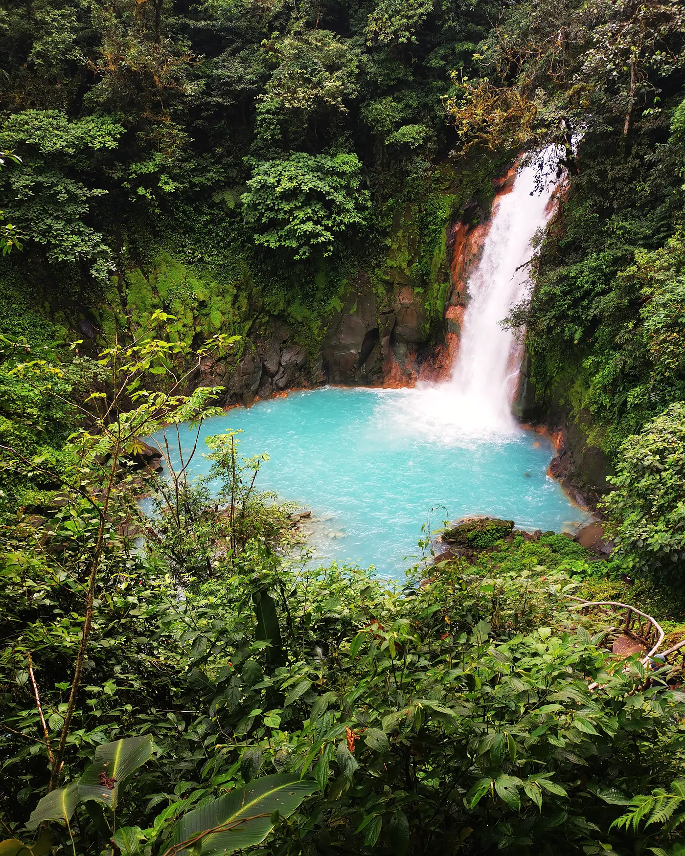 The turquoise Rio Celeste waterfall in the Costa Rican jungle