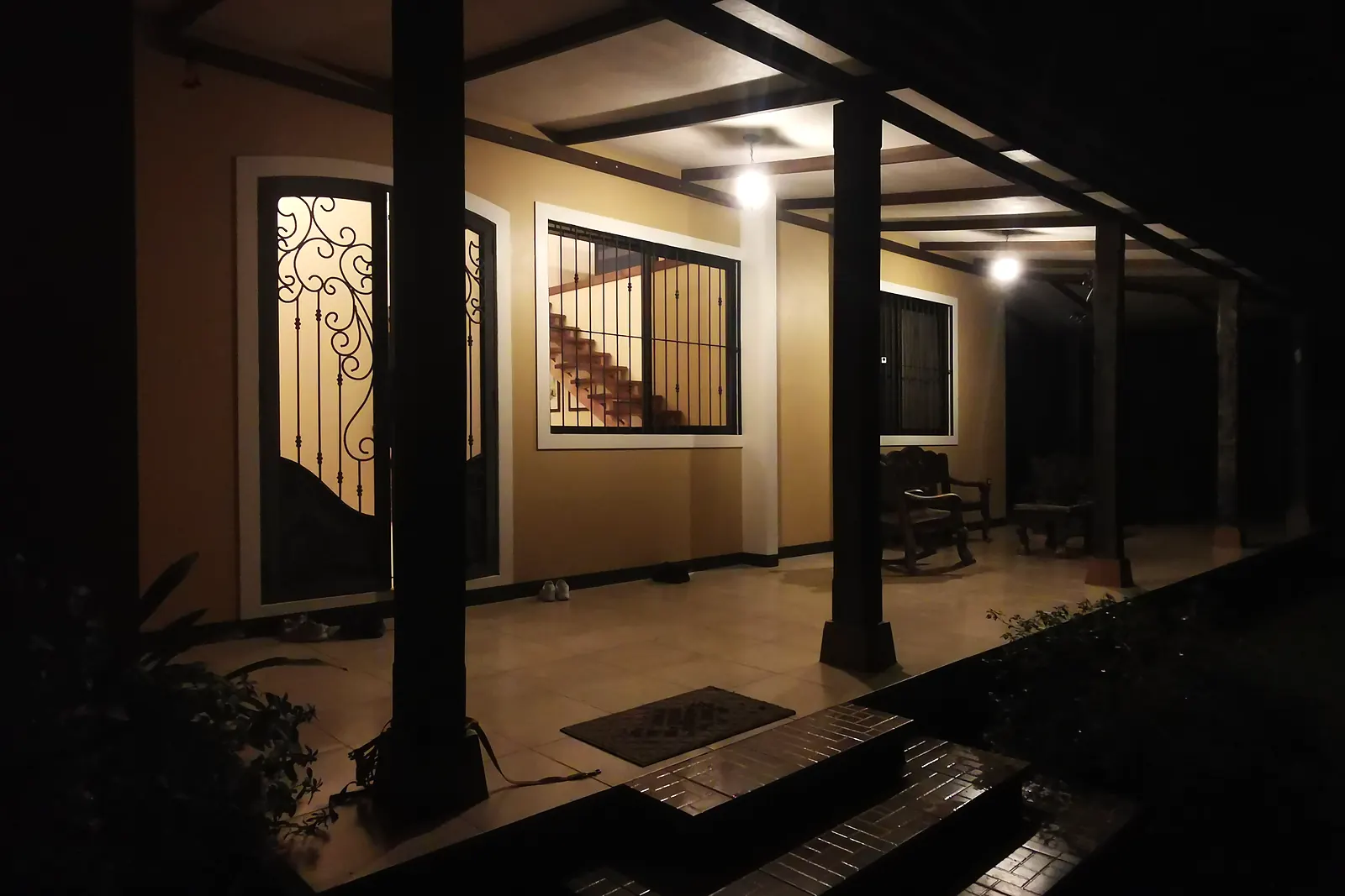 The lit veranda of the main house at dusk